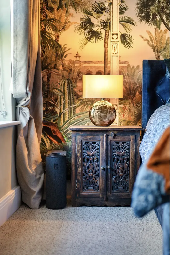 Bedroom feature-wall detail with upholstered headboard and pendant lighting at Ascot