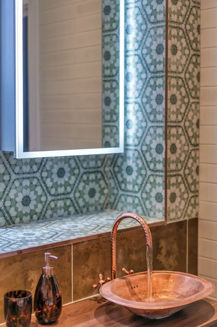 Copper basin and patterned wall detail in the completed Ascot renovation