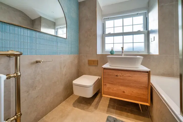 Contemporary bathroom with freestanding bath and dark vanity at Ascot