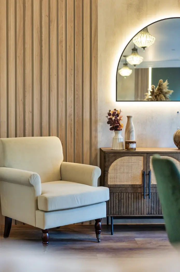 Armchair and timber-slat feature wall in the completed Ascot renovation