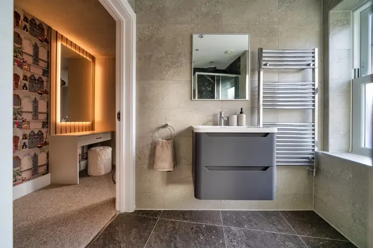Bathroom vanity, patterned floor and window detail in the completed Ascot renovation