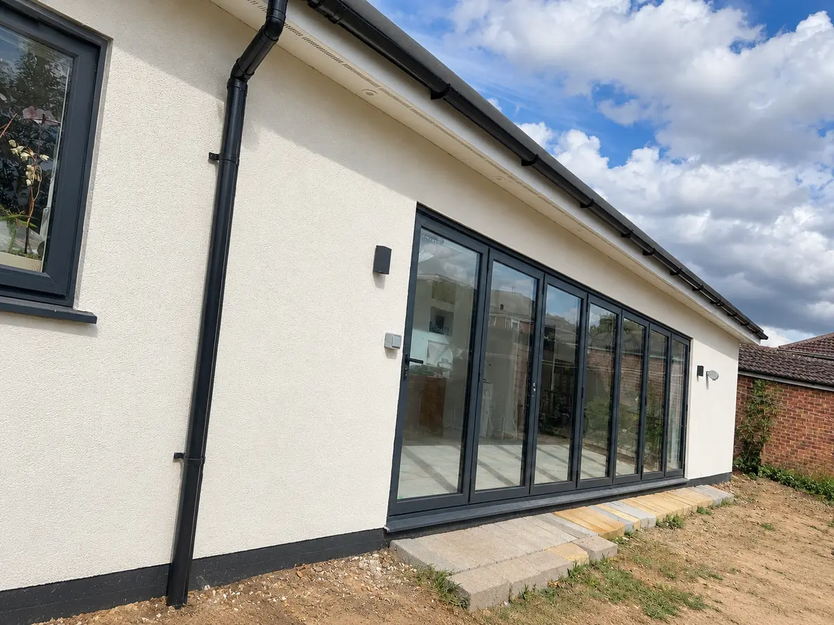 Completed rear extension with full-width glazed doors at Denham