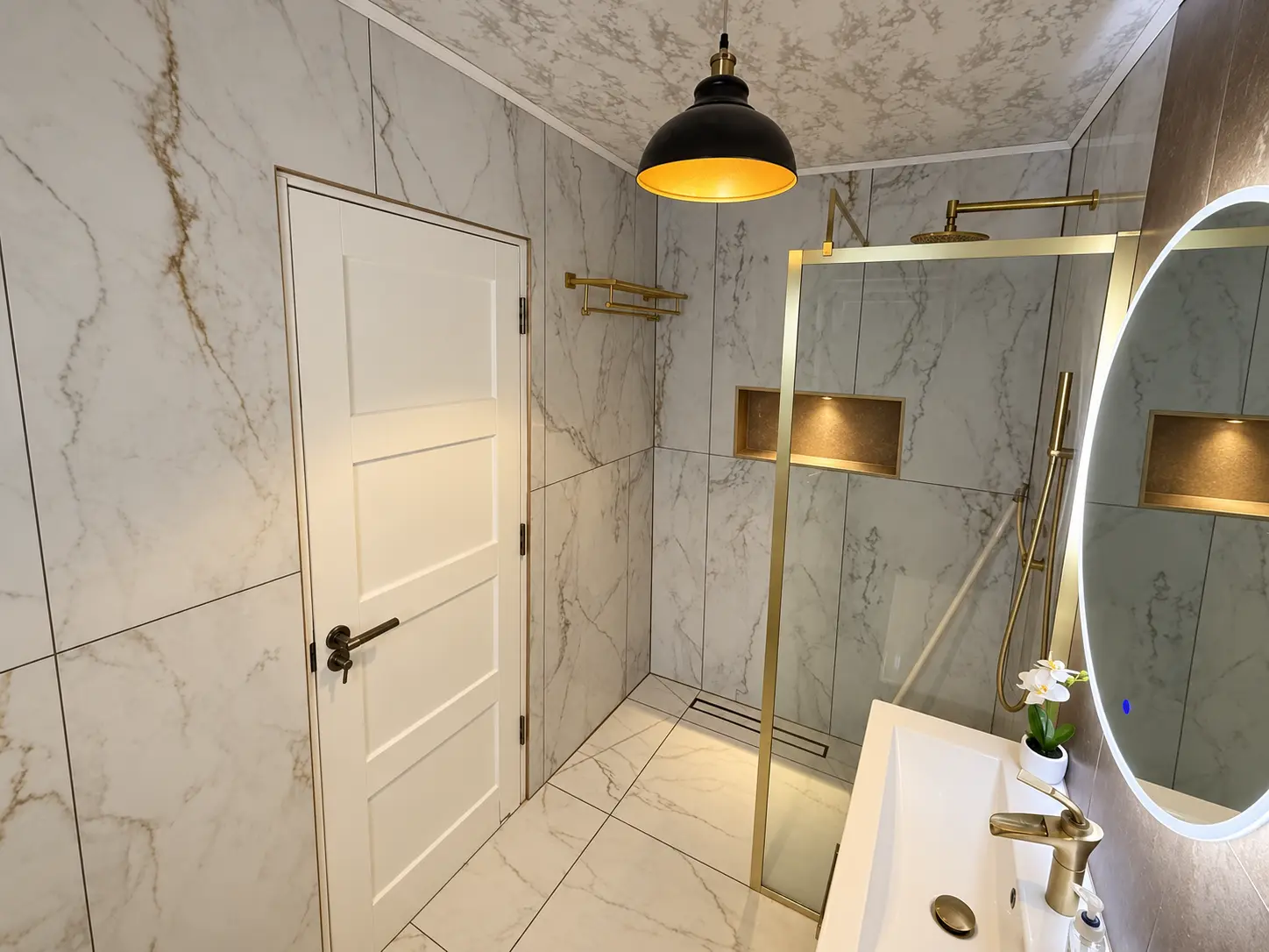Completed bathroom with gold fittings at Farnham Royal