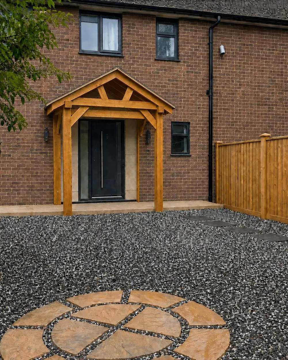 Completed Farnham Royal new-build entrance with oak porch and matching timber boundary fence